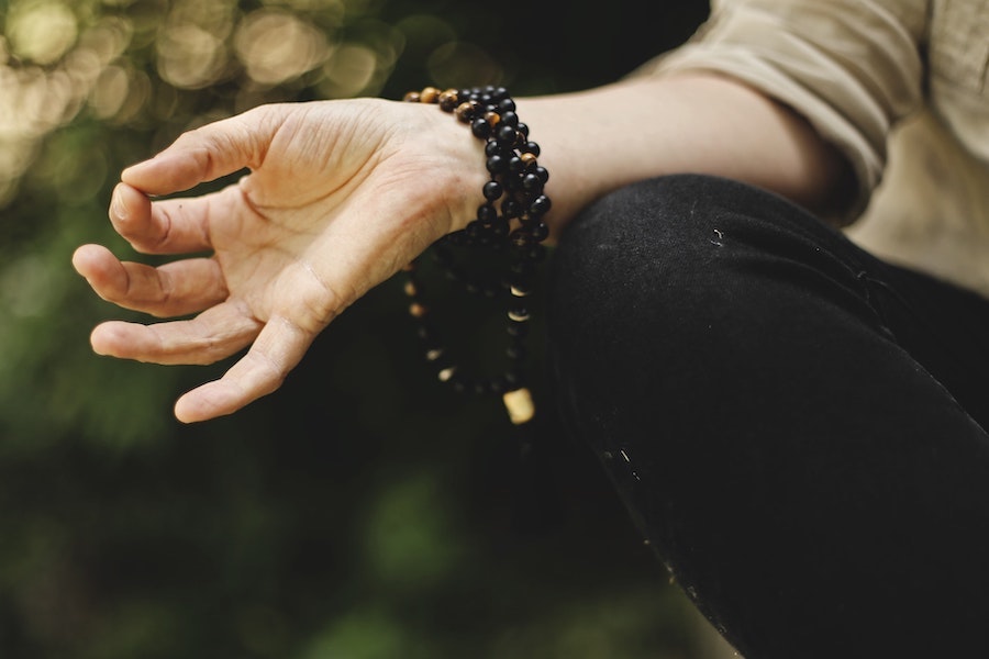 Hand on knee in a meditation pose
